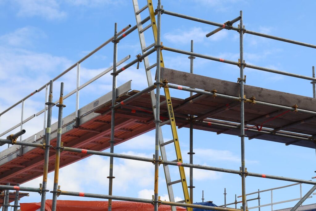 pexels photo 31745718 Detailed view of a construction site scaffolding structure and ladder against a bright blue sky.